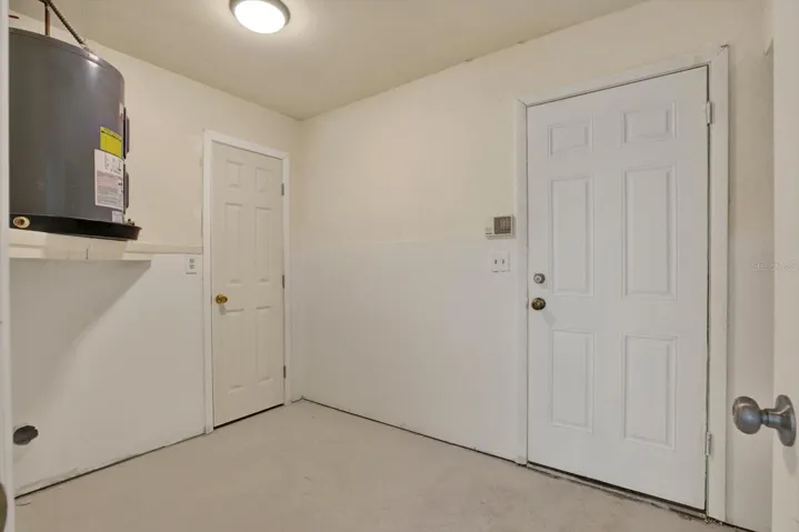 Convenient indoor laundry room offering dedicated space for standard washer and dryer hookups.