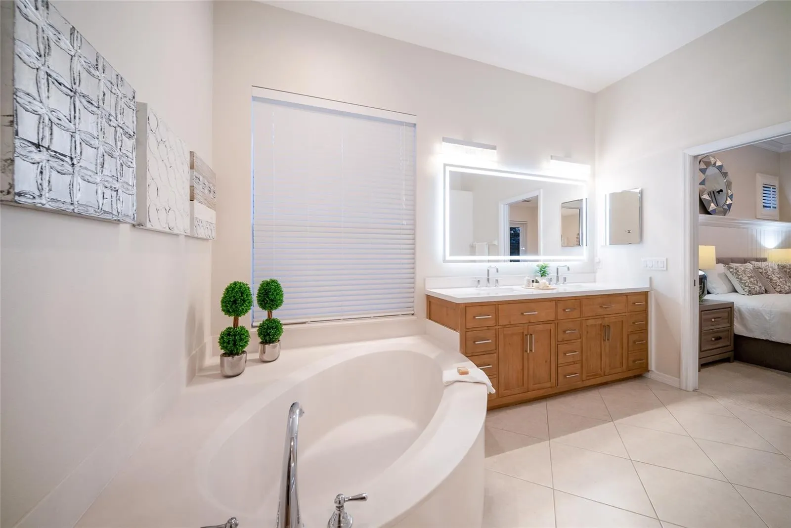 Primary Bath with dual sinks, soaking tub, step in shower, new cabinets, new countertops, new LED Mirror and light fixtures.