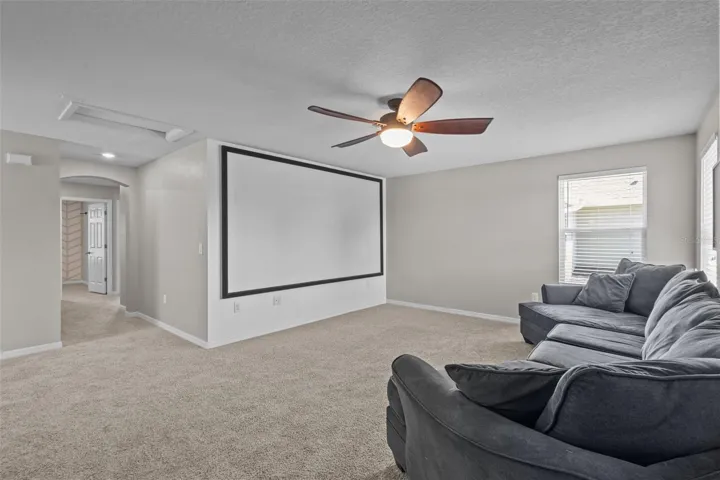 Currently used as a media room, the spacious loft offers flexibility for entertainment, play, or relaxation