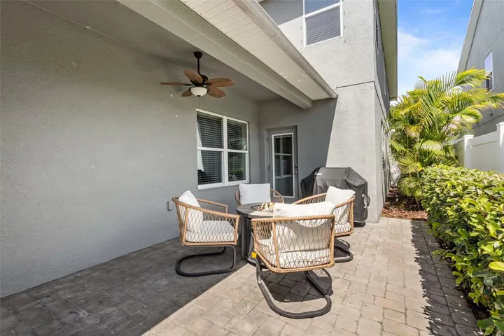 Rear exterior showcases the extended paver patio and detached garage