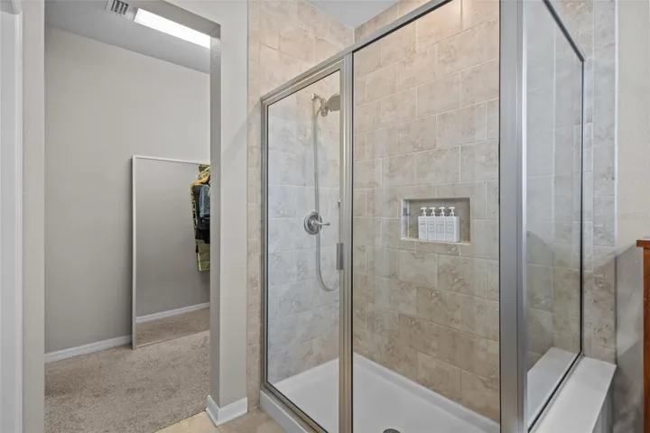Primary bathroom features dual sinks, granite countertops, and a walk-in shower.