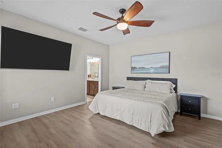 Spacious main-level primary bedroom offers a private retreat from the secondary bedrooms upstairs