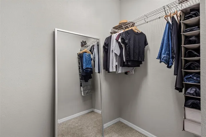 Large walk-in closet provides generous storage within the primary suite