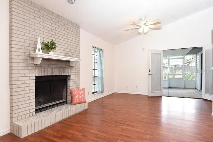 Greatroom with fireplace with french doors to screened porch