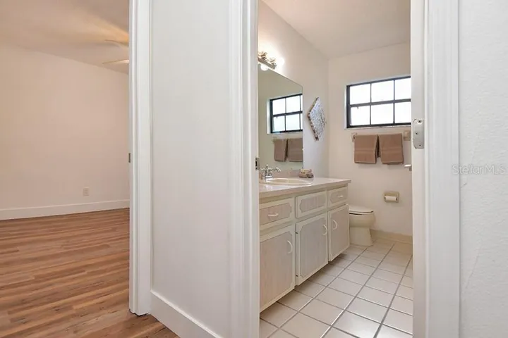 The guest bedroom is conveniently next to the guest bathroom