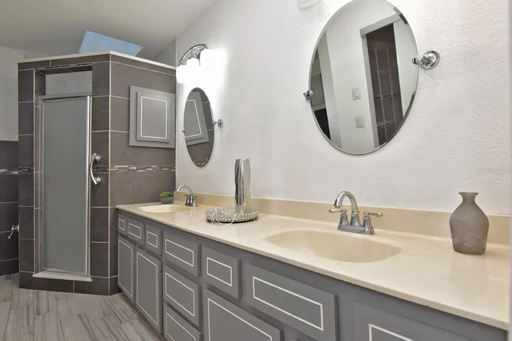 Primary ensuite with double sink vanity and walk-in shower