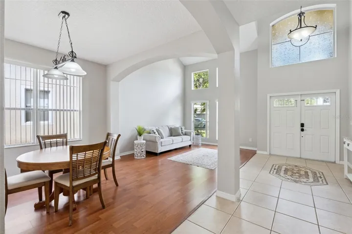 Natural light and soaring ceilings make the front living area and dining room feel open and inviting.
