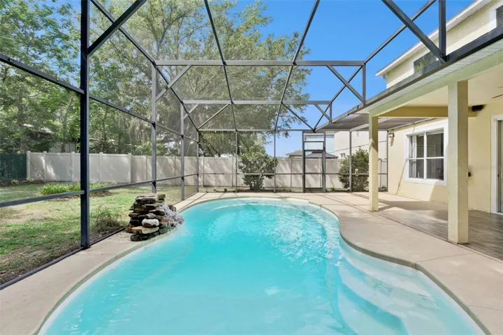 Privacy, pool living, and open skies behind the home.