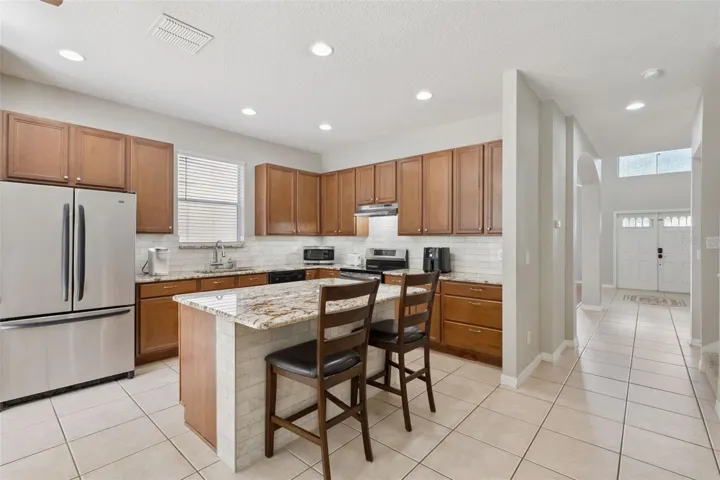 Granite counters, backsplash and a center island with seating!