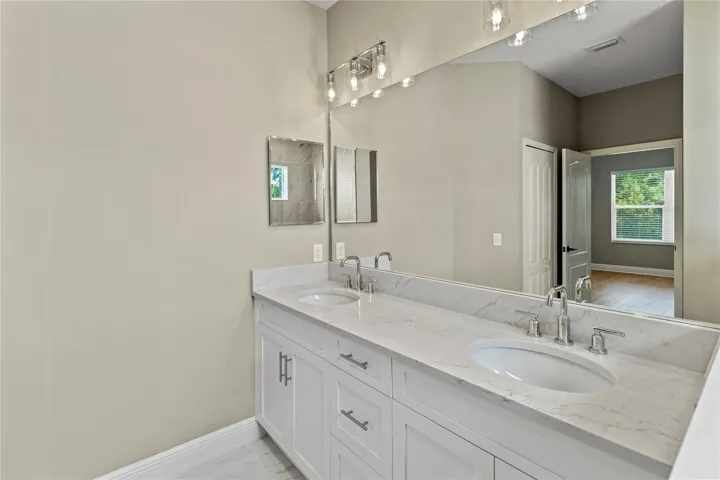 Primary bath has dual sinks, water closet