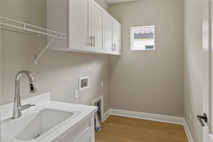 Laundry with sink and washer dryer provided