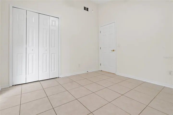 bedroom 2 with sliders to patio