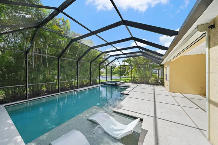 Very large natural gas heated pool and spa, complete with sunshelf and seating within the pool