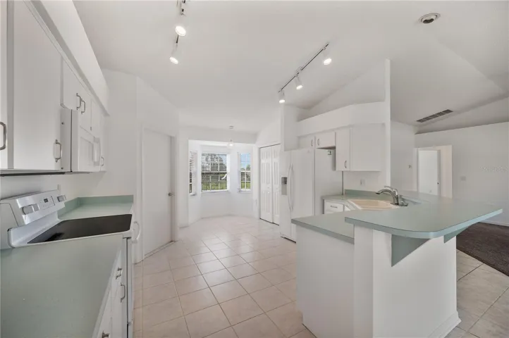 Kitchen with breakfast bar, closet pantry, and eat-in nook