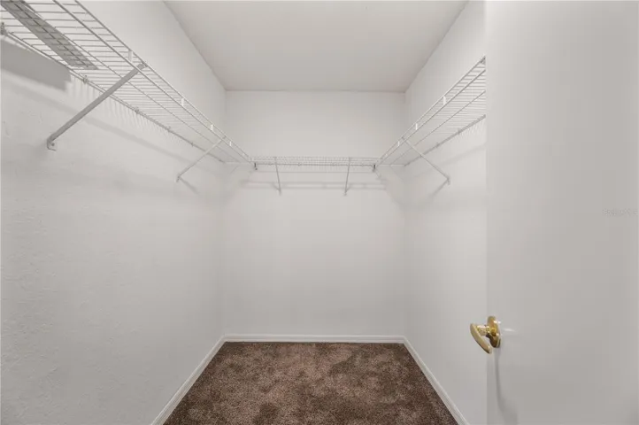Primary bedroom walk-in closet