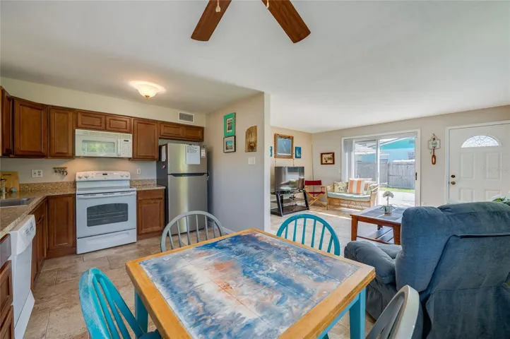 Multi-angle view of the functional kitchen and dining area, illustrating a fluid connection to the main living space for effortless entertaining.
