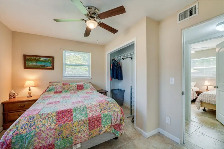 Bright bedroom with neutral colors and ceiling fan