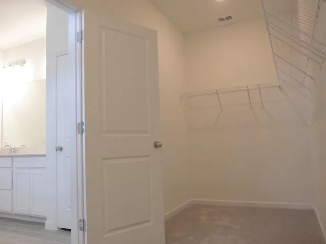 Inside primary bedroom walk-in closet