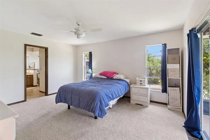 Large Primary Bedroom with sliders to the screend in porch