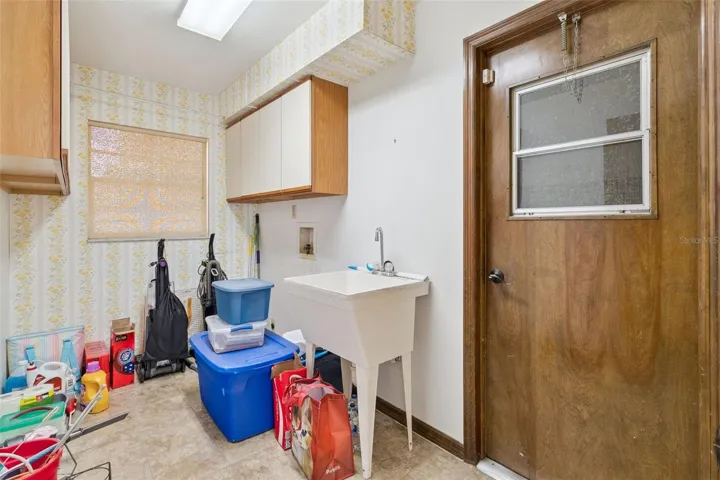Indoor utility room with access to the garage and sink
