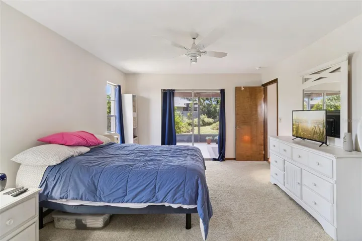 Large Primary Bedroom with sliders to the back screened in porch