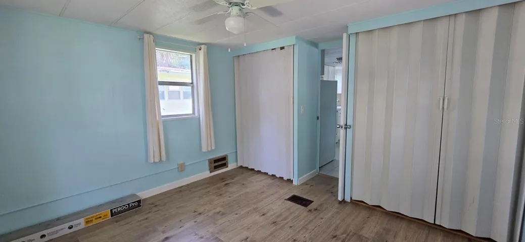 Bedroom 1 — Double Closets Primary bedroom with double closet space, ceiling fan, natural light, and new flooring — plenty of room for your furniture and storage.