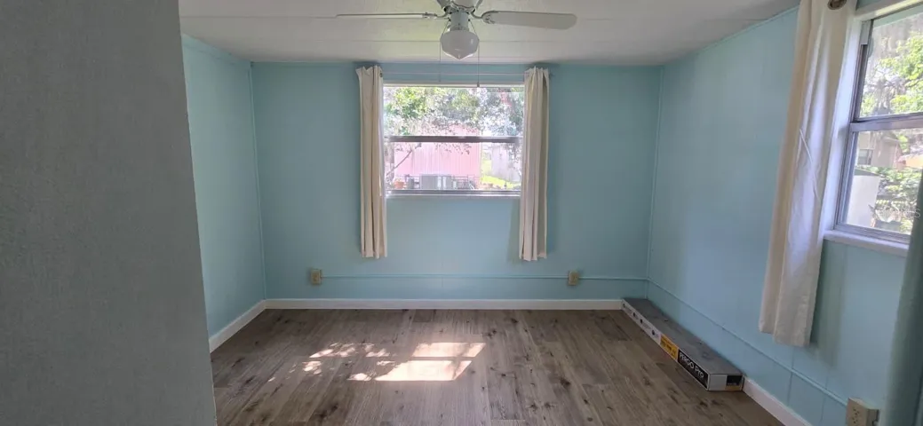 Bedroom 1 — SunlitSun drenching the new floors in the afternoon — this bedroom is peaceful, quiet, and move-in ready