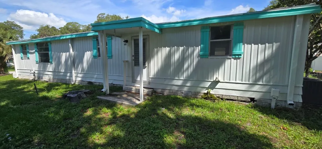 Front ExteriorCharming 2/1 with fresh curb appeal — teal shutters, covered entry, and mature shade trees set the tone the moment you pull up