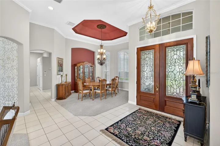 Entry through beautiful double doors into a large open foyer.