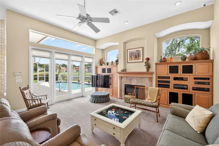 The family room is just off the kitchen, the custom built-ins flank the fireplace with plenty of storage for audio visual equipment.