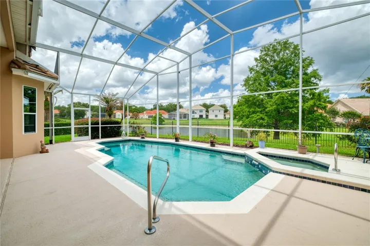 Pool overlooks pond and fountain.