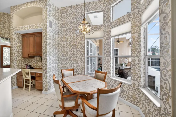 Beautiful windows with views to the pool create a tranquil casual dining area in the kitchen.