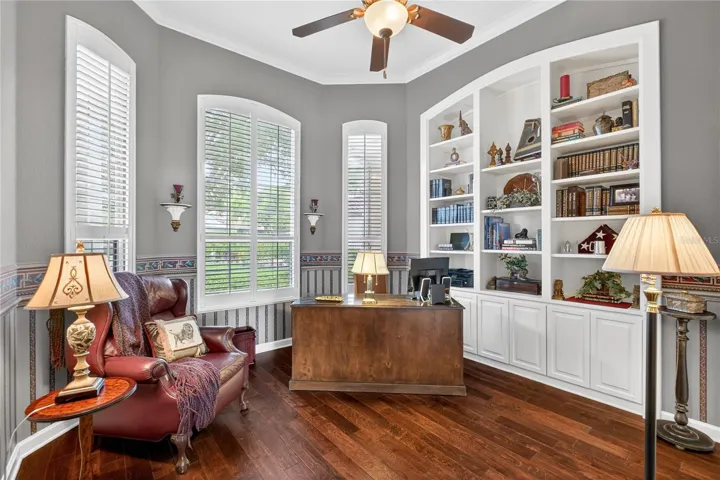 This private office with closet and beautiful built-in bookcase is just off the foyer opposite the dining room.