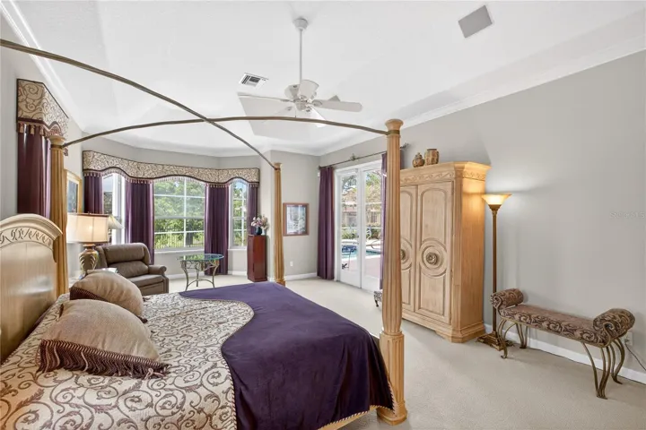 Primary bedroom with doors to pool.