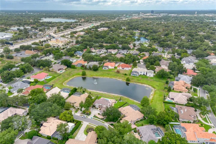 1911 Belford overlooks pond with fountain.