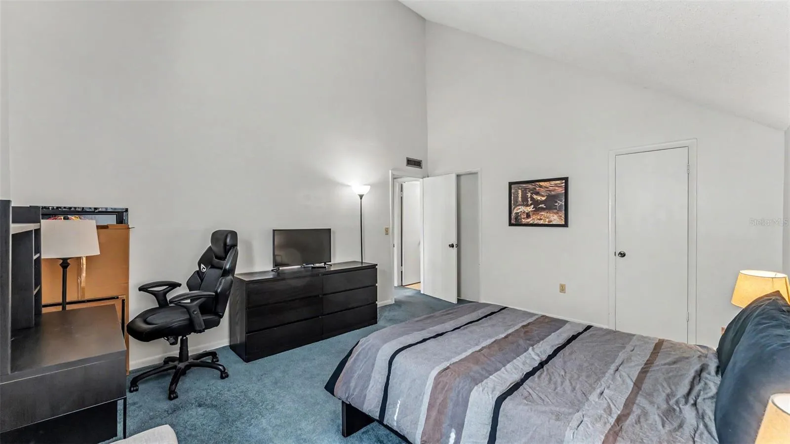 spacious bedroom suite with vaulted ceilings