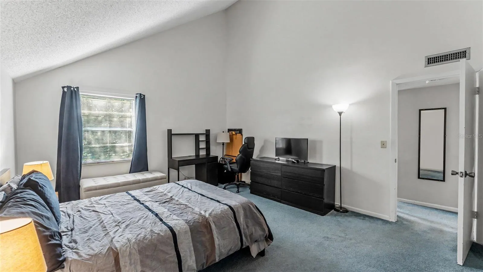 spacious bedroom suite with vaulted ceilings