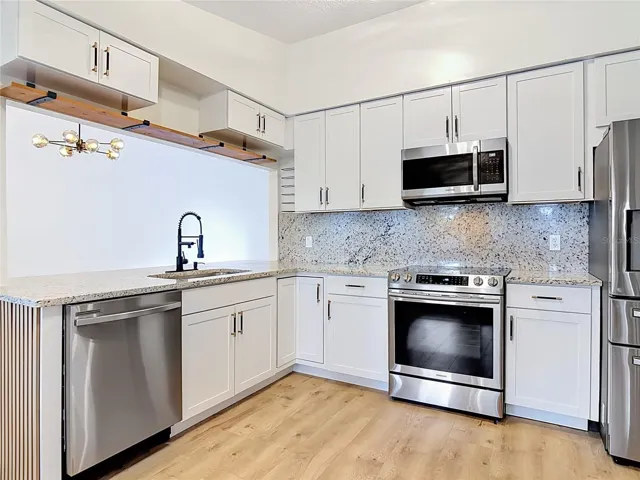 Kitchen, notice the granite flows from countertop to backsplash.
