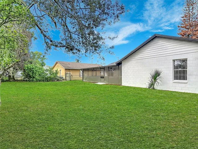 Backyard view to the house, showing screened porch.