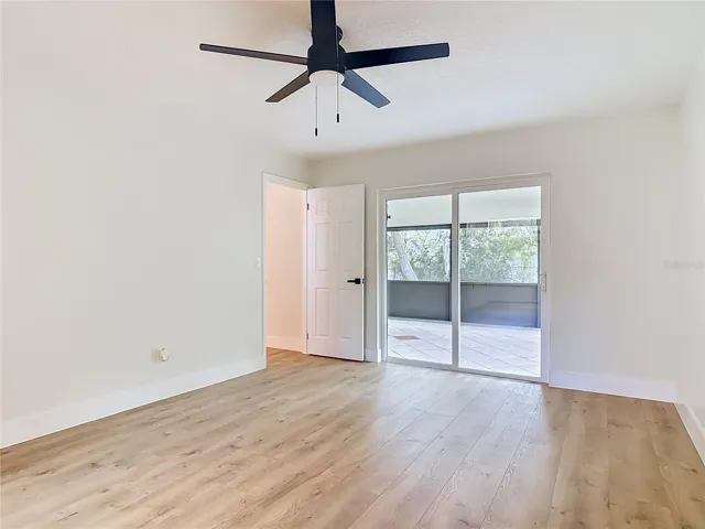 Primary Bedroom with sliding doors to the covered Porch.