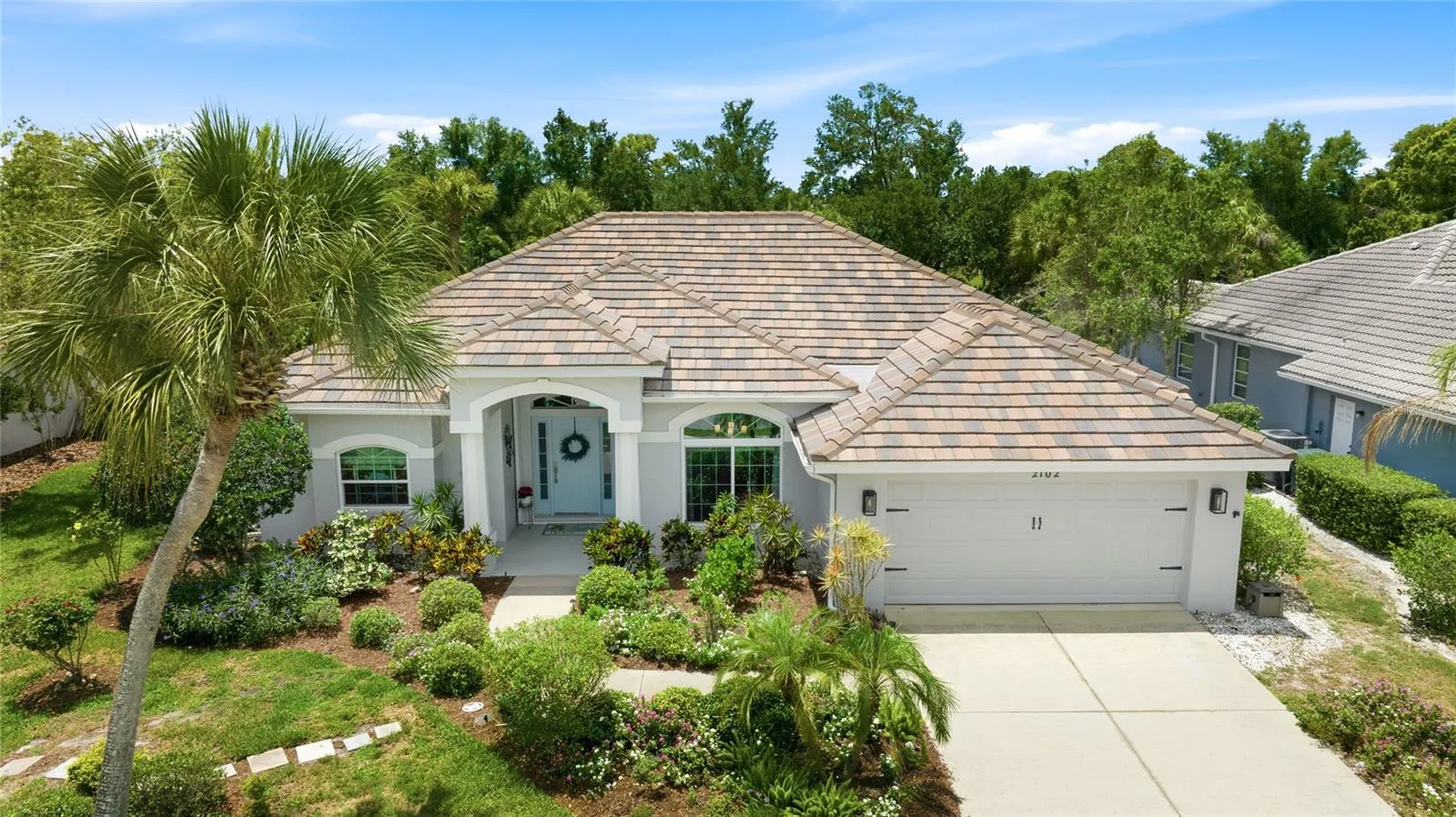 Exterior Front of Home with Tile Roof and professionally installed landscaping