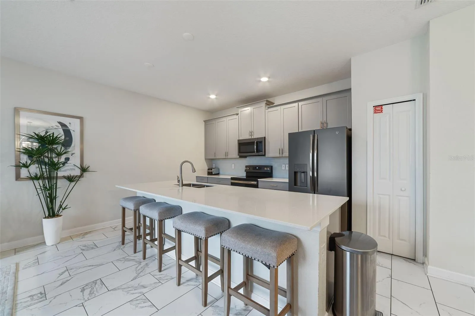 The STYLISH KITCHEN is designed to impress with an abundance of 42-inch cabinetry, stone countertops, SUBWAY TILE BACKSPLASH, stainless steel appliances, and a spacious island with breakfast bar seating, perfect for gathering with family and guests.