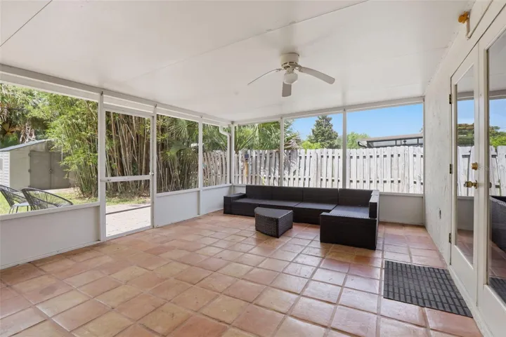 The enclosed patio offers the perfect extension of the living space, creating a relaxing spot to enjoy year-round Florida living in comfort.