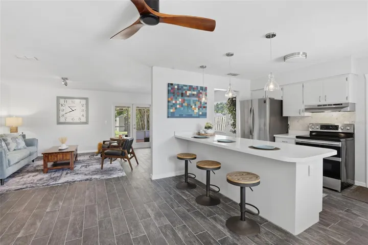 The kitchen features a convenient breakfast bar, perfect for casual dining, morning coffee, or gathering with family and friends.