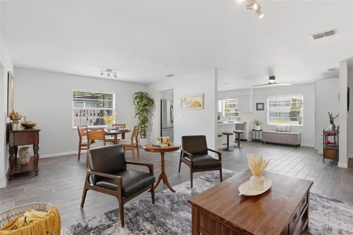 The open-concept family room, dining area, and kitchen flow seamlessly together, creating a bright and inviting space perfect for everyday living and entertaining.