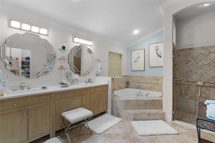 Primary bath with upgraded cabinets, mirrors & lighting