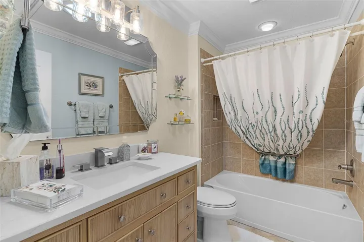 Front guest bath with quartz countertops & tile/tub combo
