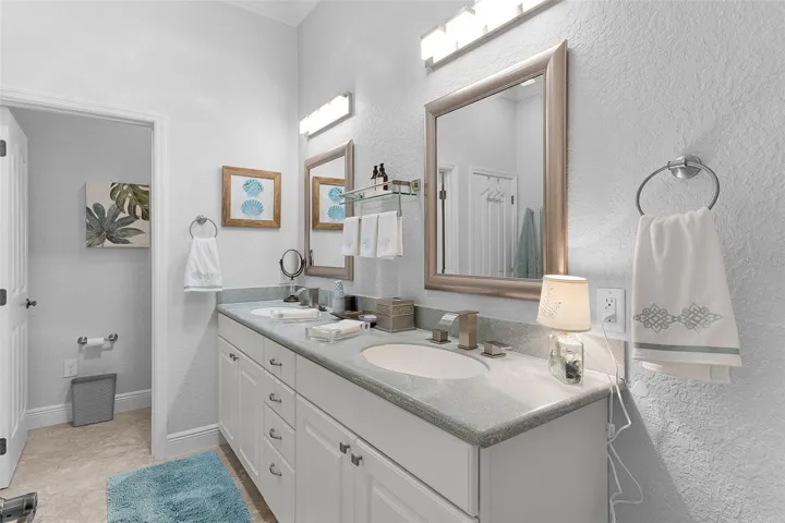 Bath added on in new area to the east side of the home.  Features Corian countertops, double sinks & a separate commode.