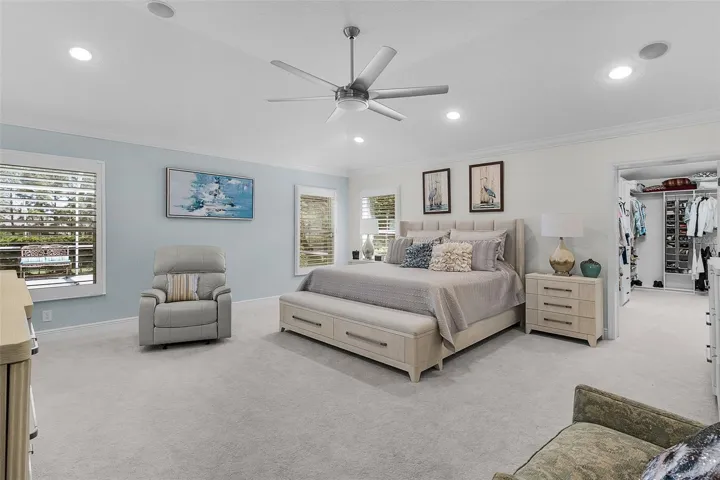 Primary bedroom with plush carpet & plenty of room. Nice updated ceiling fan & bright recessed lighting!
