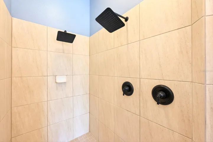 Primary suite tiled walk-in shower.